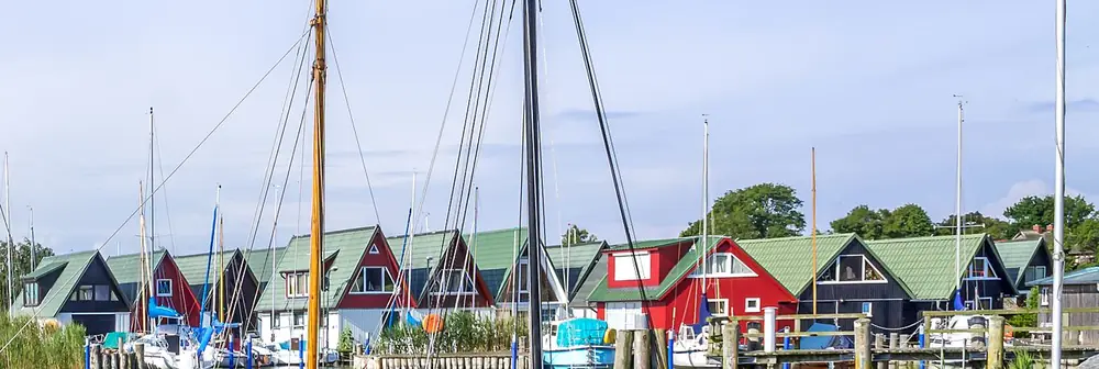 Rote und schwarze Bootshäuser am Hafen