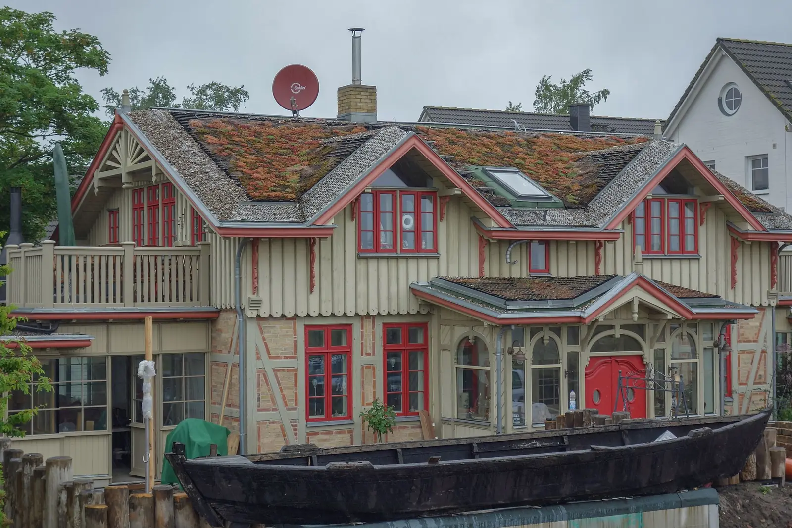 Historisches Holzhaus mit roten Fensterrahmen in Zingst